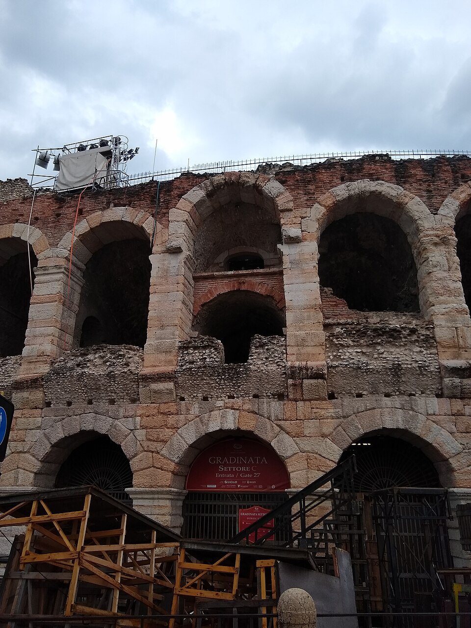 Tall arches of the outer wall, the ground-floor openings in red