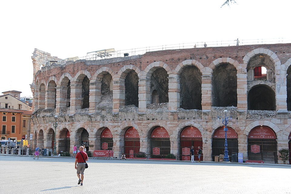 The Arena's arcades from Piazza Bra, red gates closing the ground-floor arches