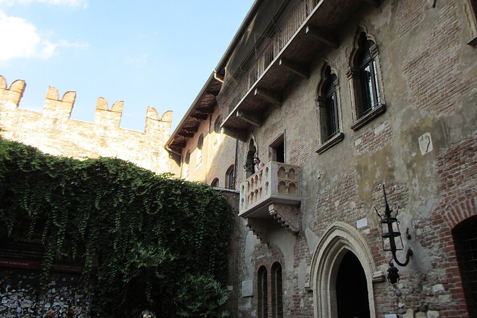 The house front with its ivy and the courtyard's battlemented wall
