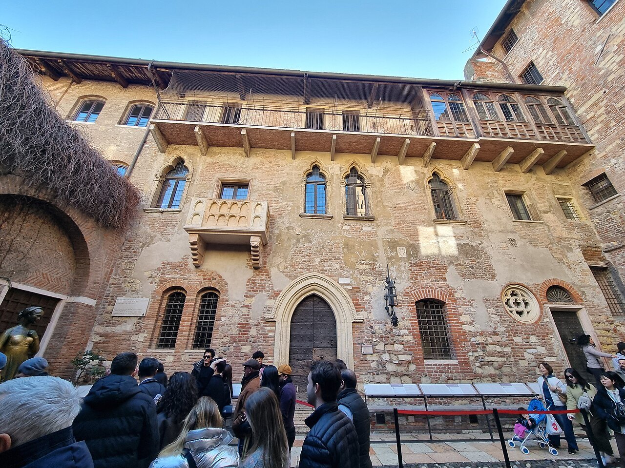 The balcony and brick front of Juliet's House seen from the courtyard
