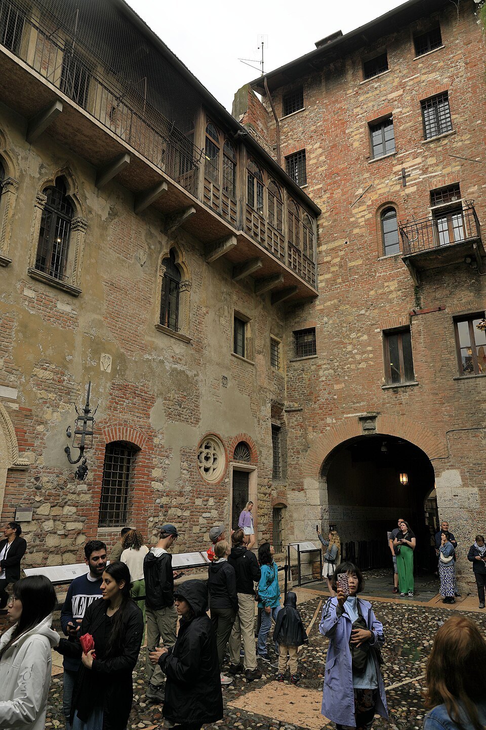 Visitors below the balcony in the courtyard