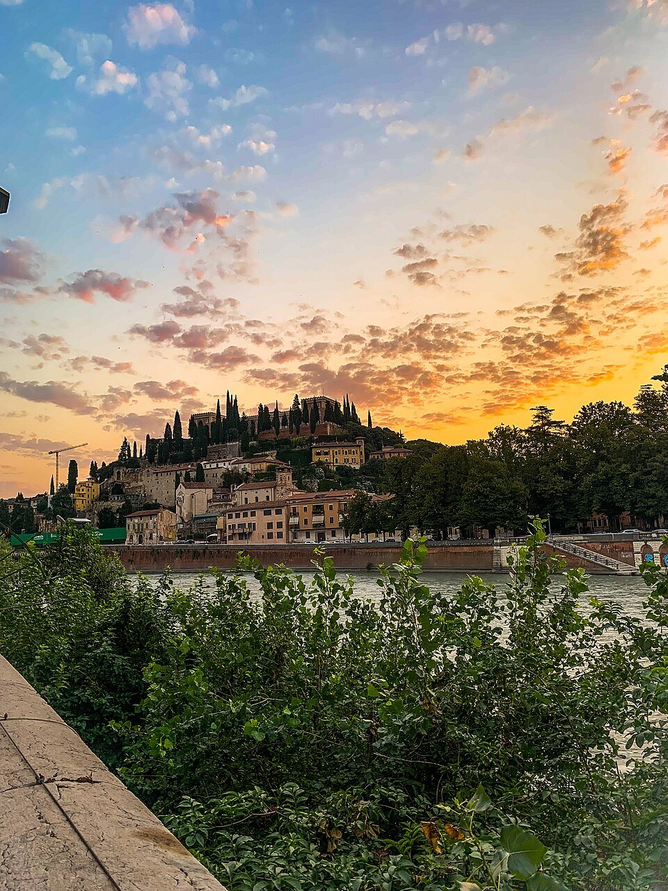 The hill at sunset from across the Adige