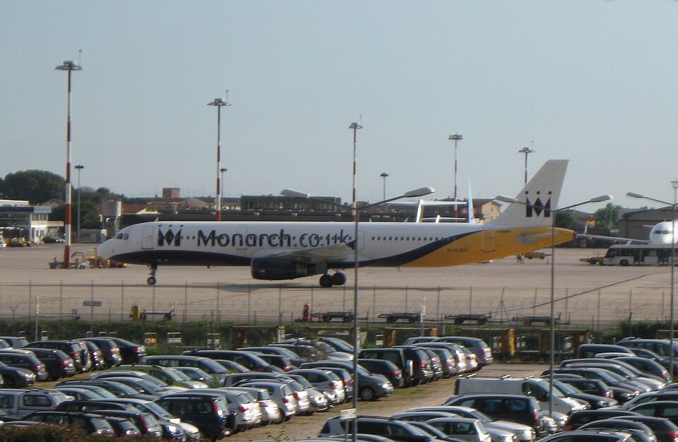 A parked airliner and car park at Verona airport