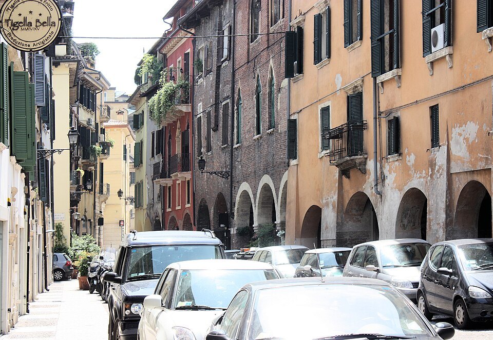 Via Sottoriva, its low arcades and parked cars
