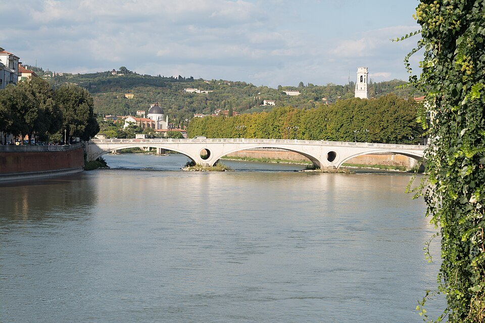 The Ponte della Vittoria's white arches over the Adige