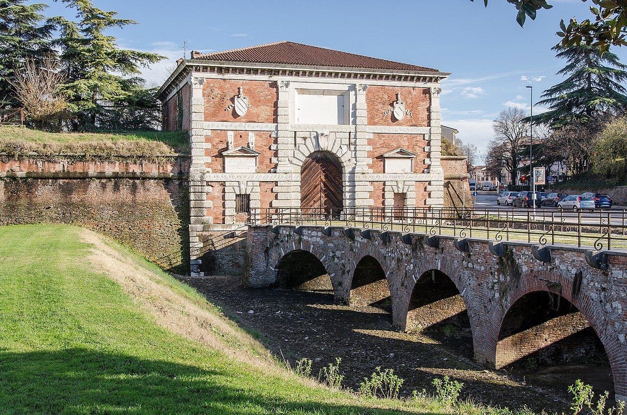 Porta San Zeno, the brick city gate, with its arched bridge over the grassed moat