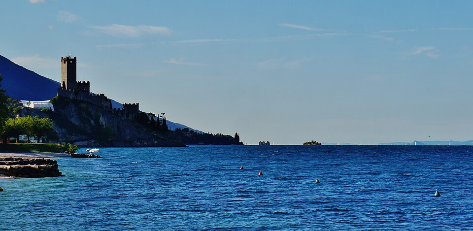Malcesine's castle above the blue water of Lake Garda