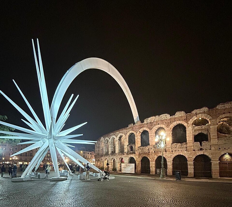 The Christmas star arching over Piazza Bra beside the lit Arena