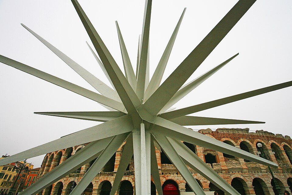 The spikes of the Christmas star against the Arena's arches