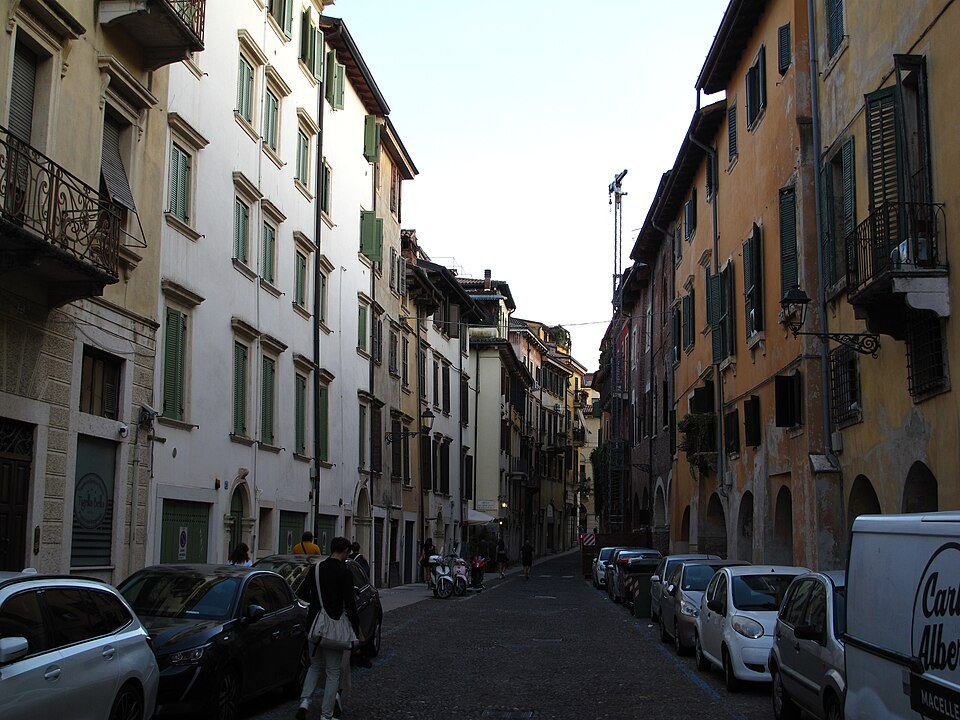 Via Sottoriva lined with parked cars