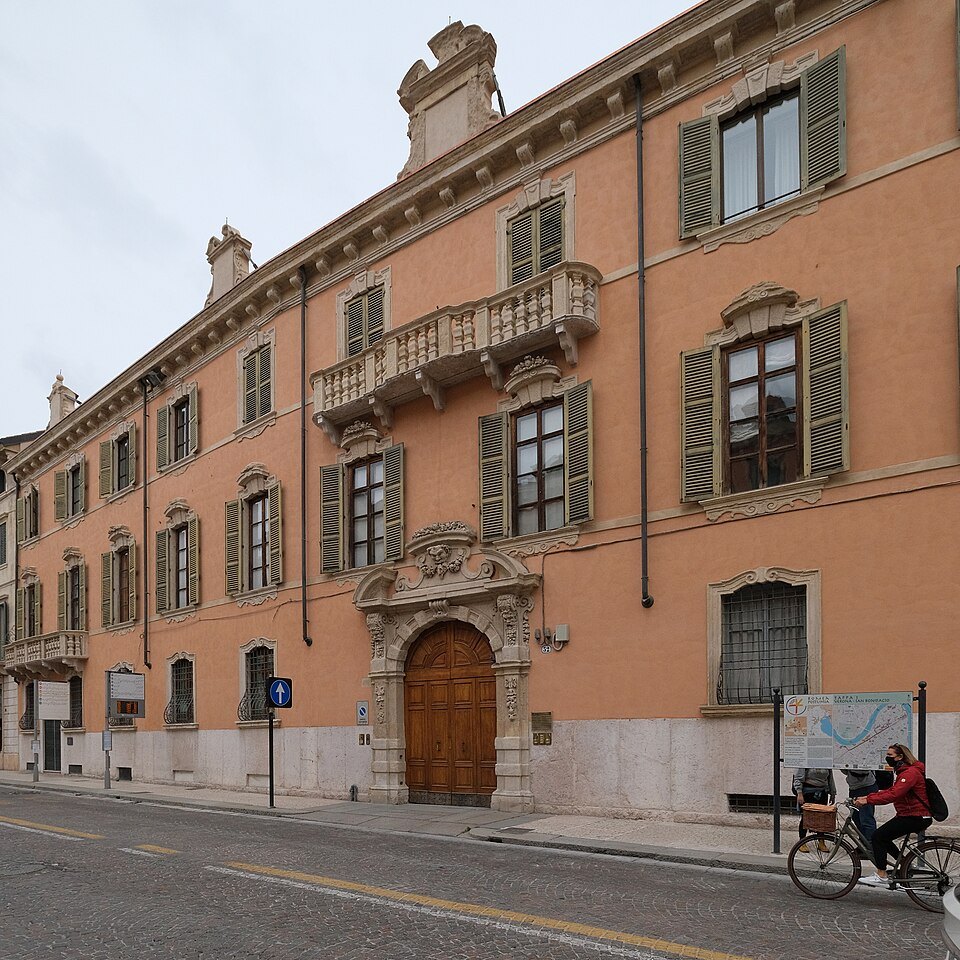 A cyclist passing a palazzo on Corso Cavour