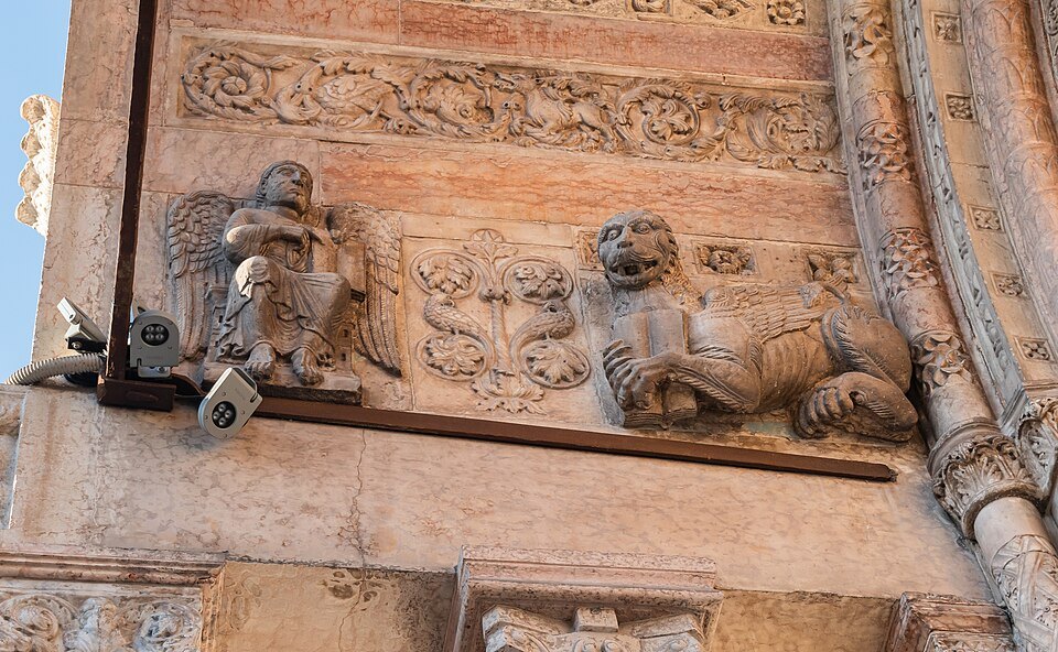 Carved Romanesque figures on the Duomo's portal