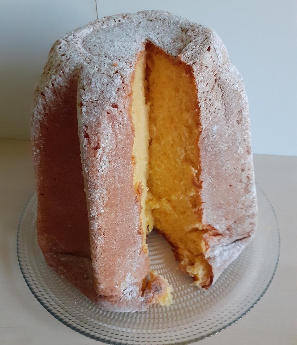 A pandoro cut open, dusted with sugar