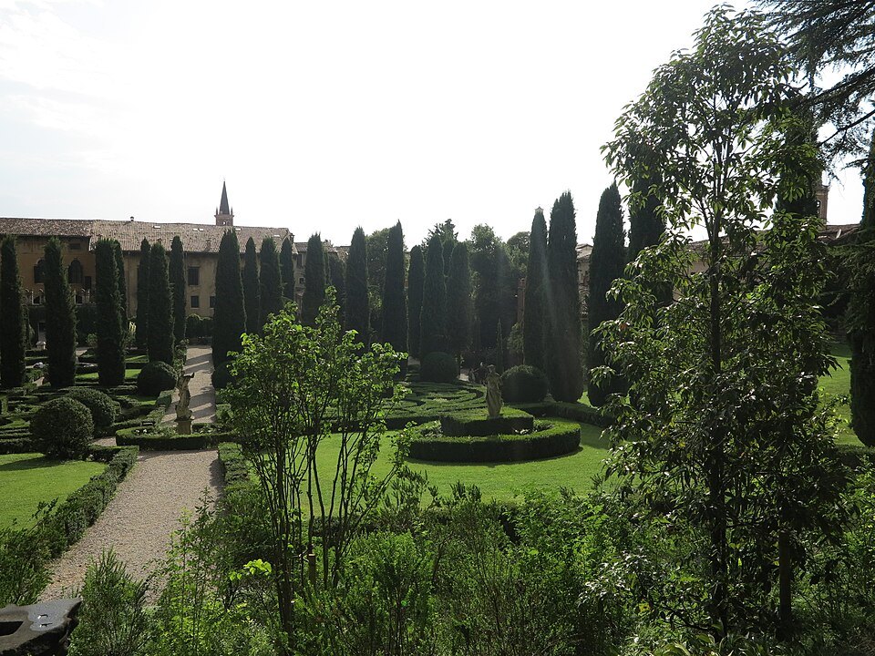 Clipped hedges and cypresses below the city walls