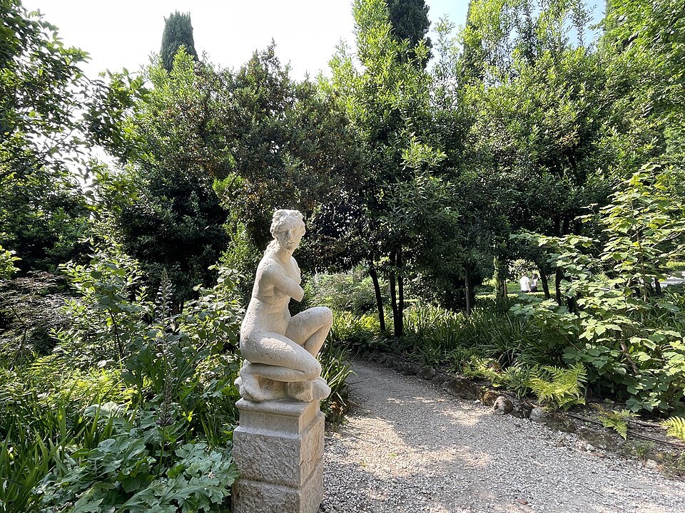 A marble statue among the trees of the upper garden