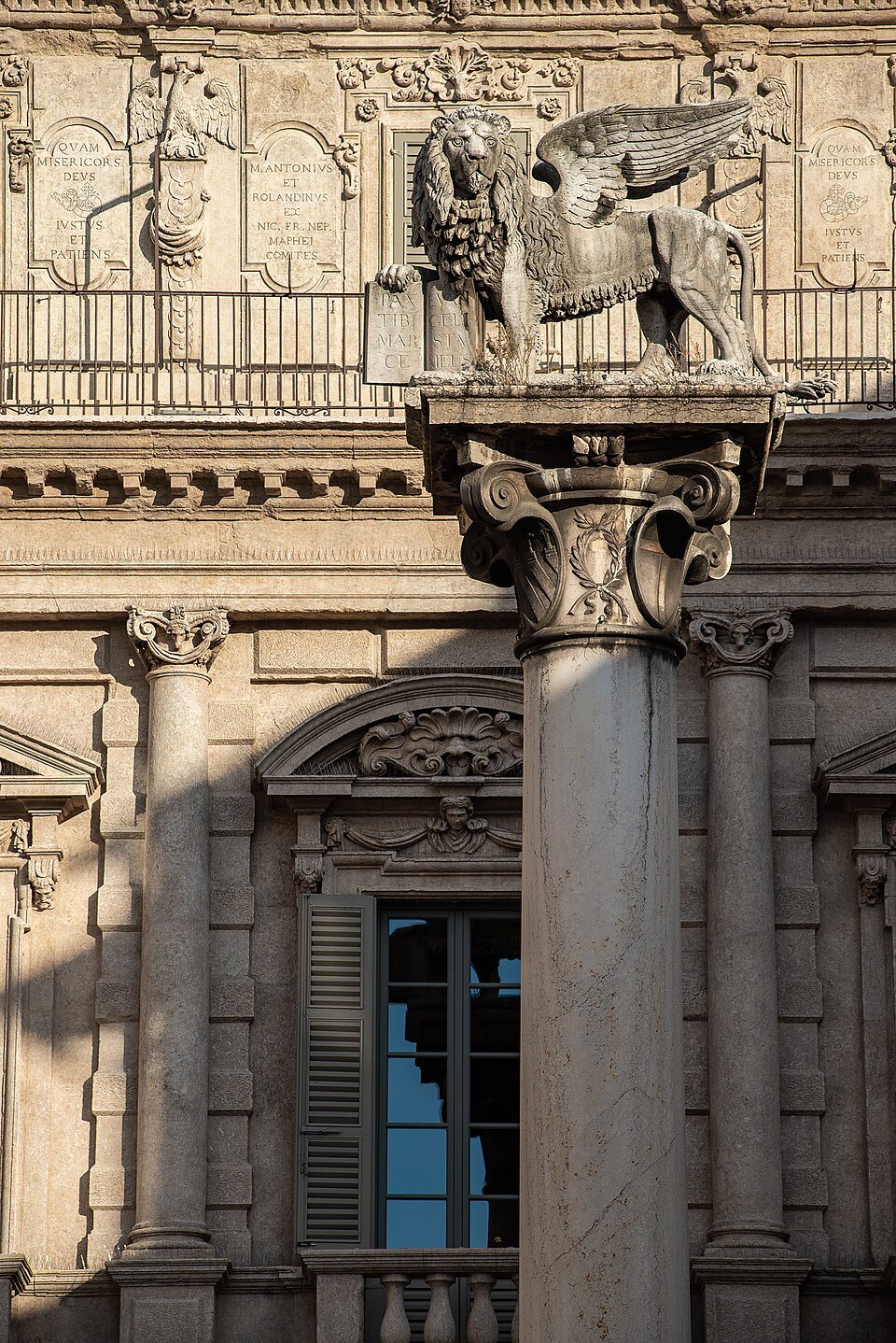 The winged lion of St Mark on its column before the palazzo