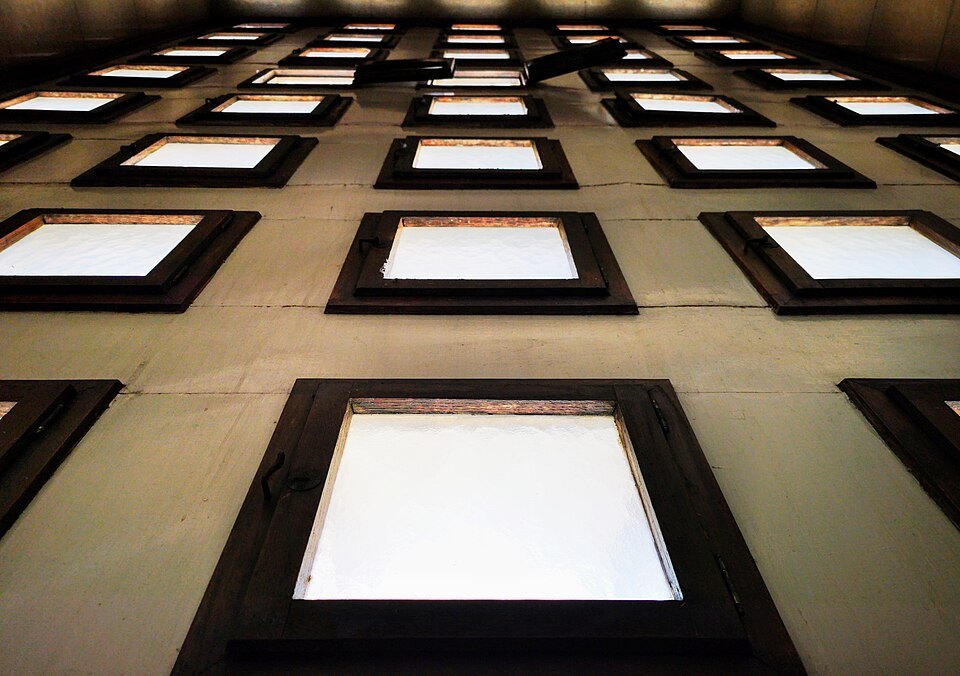 Looking straight up at the window grid of Palazzo Barbieri