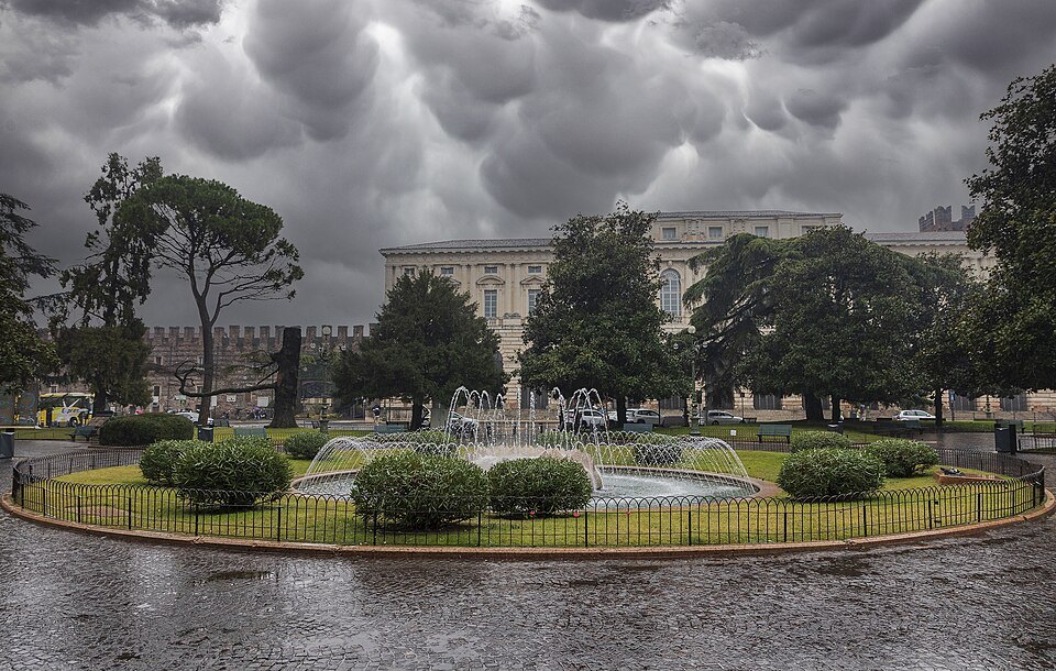 The gardens and fountain of Piazza Bra under heavy cloud