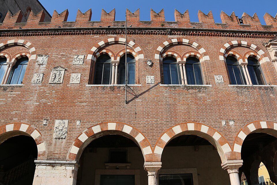 The battlemented brick front of the Domus Mercatorum