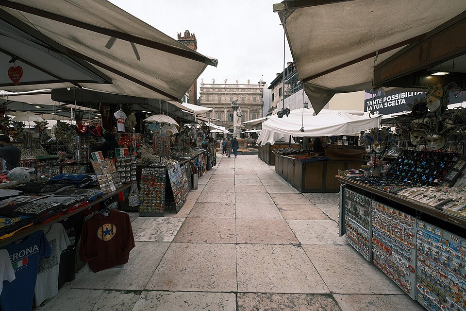 Market stalls and white umbrellas in Piazza delle Erbe