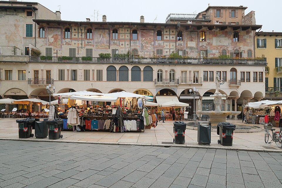 Market stalls and the frescoed Case Mazzanti in Piazza delle Erbe