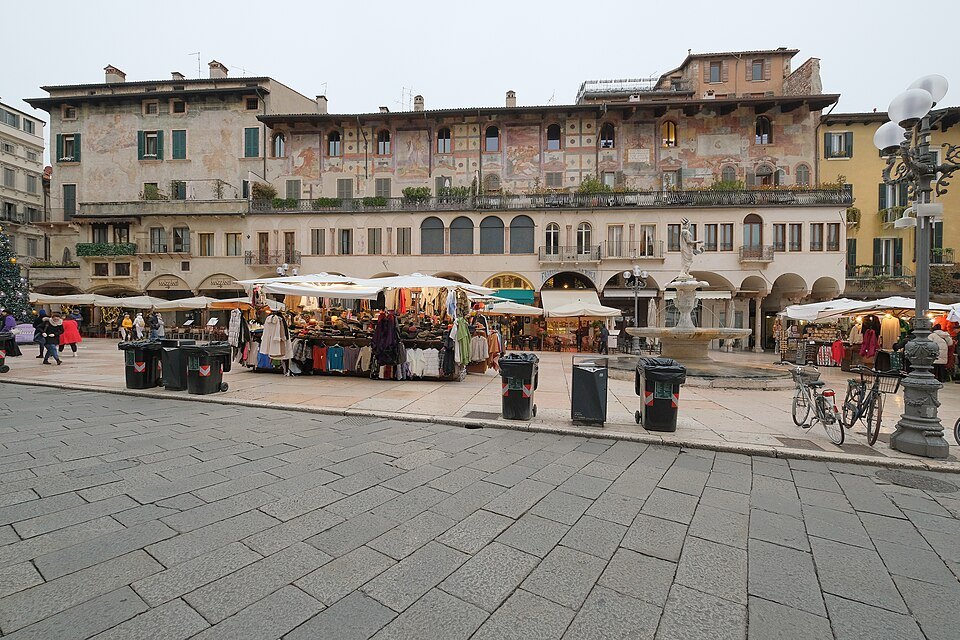 Market stalls below the frescoed Case Mazzanti