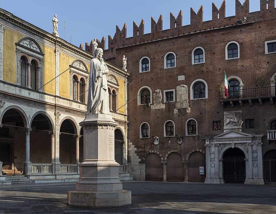 Dante's statue with the battlemented Palazzo del Podestà