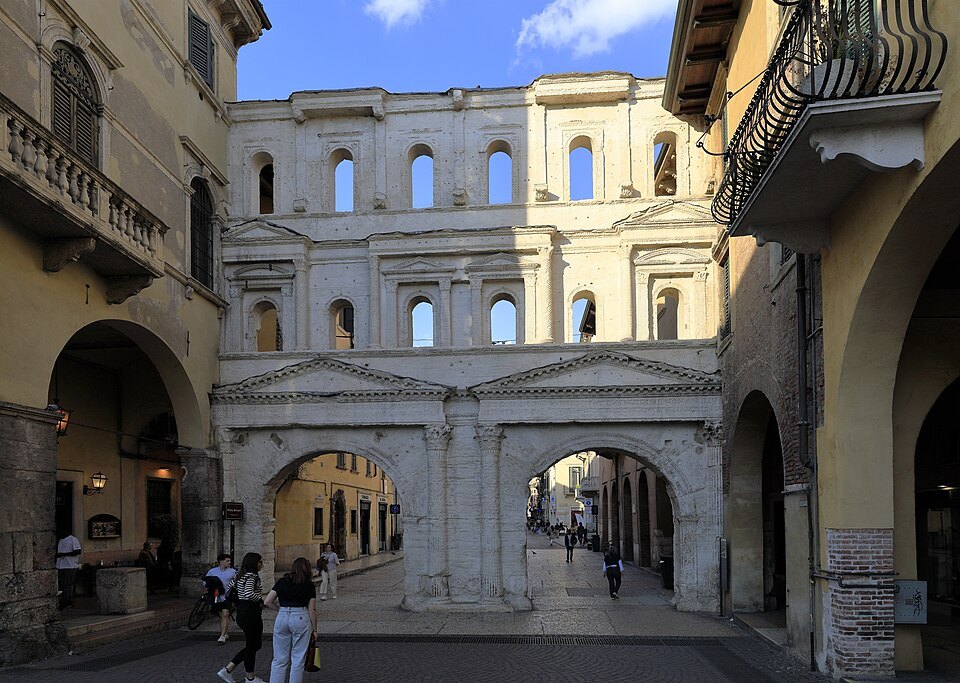 The gate across Corso Porta Borsari, shops on either side