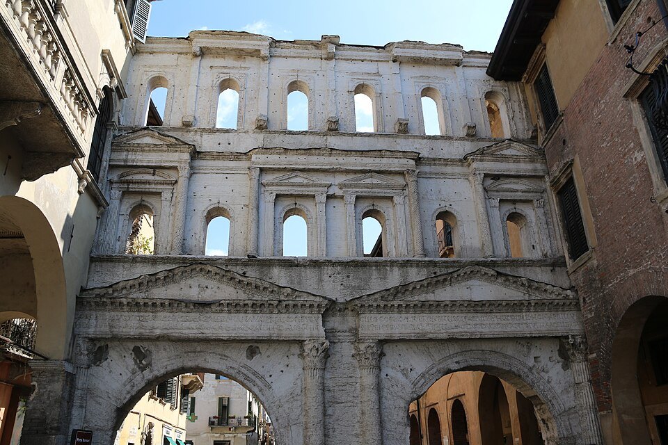 The weathered upper storey of Porta Borsari