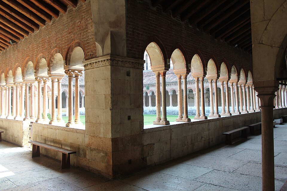 The cloister's paired columns in afternoon light