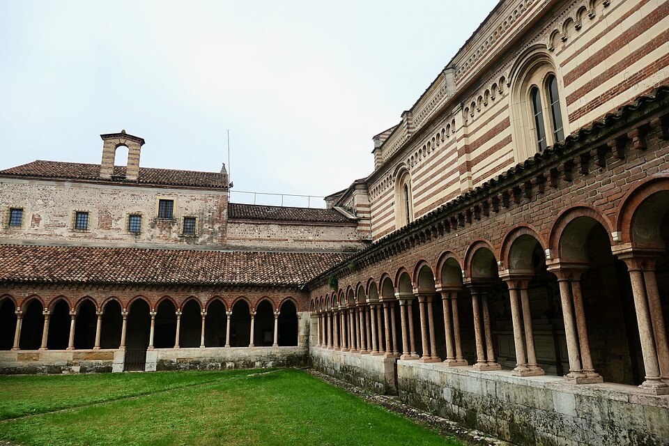 The cloister garth with the striped church wall above