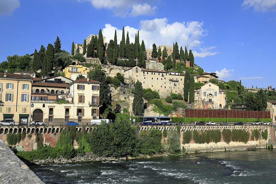The hillside of the theater and museum from across the Adige
