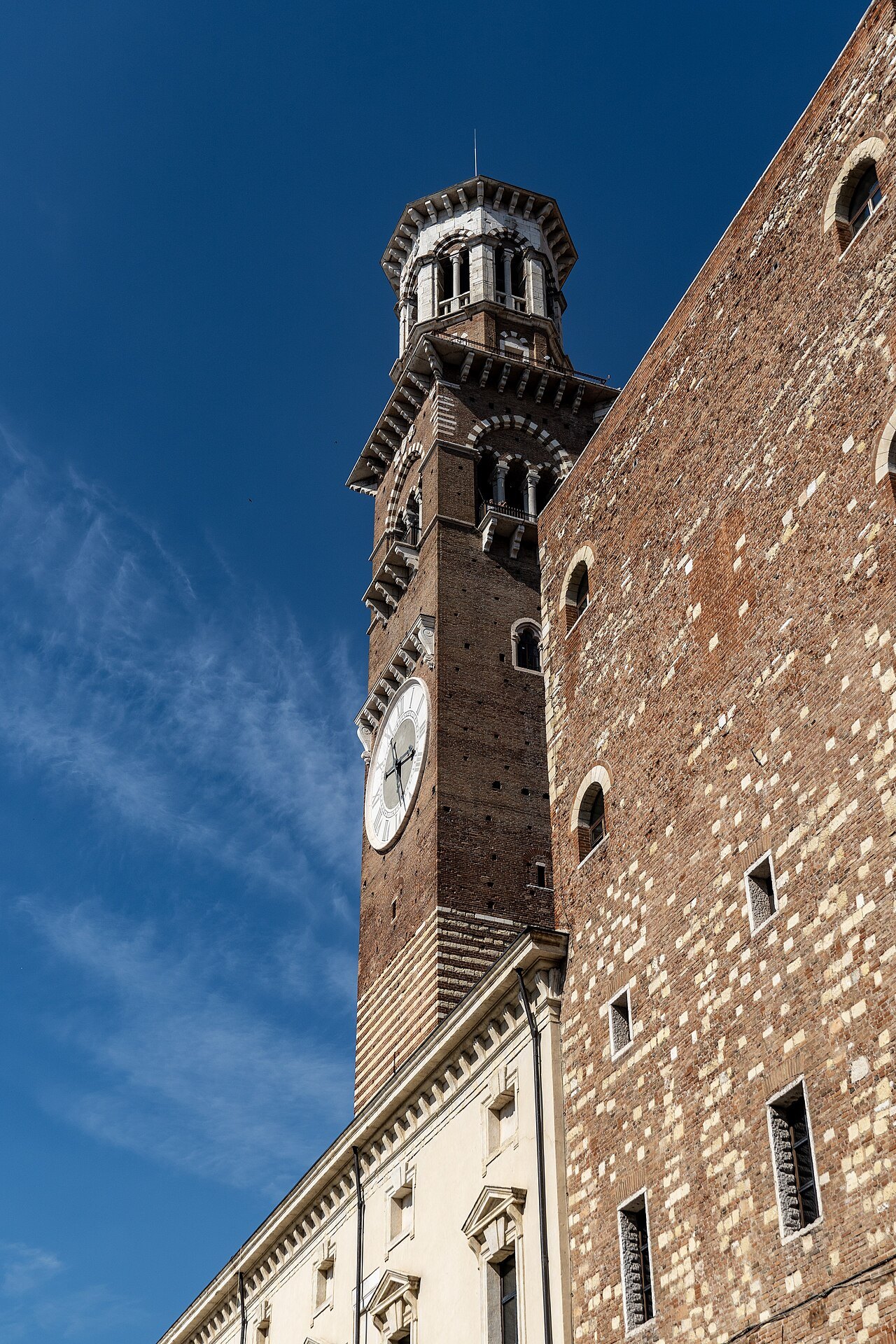 The Torre dei Lamberti rising over the roofs beside Piazza delle Erbe