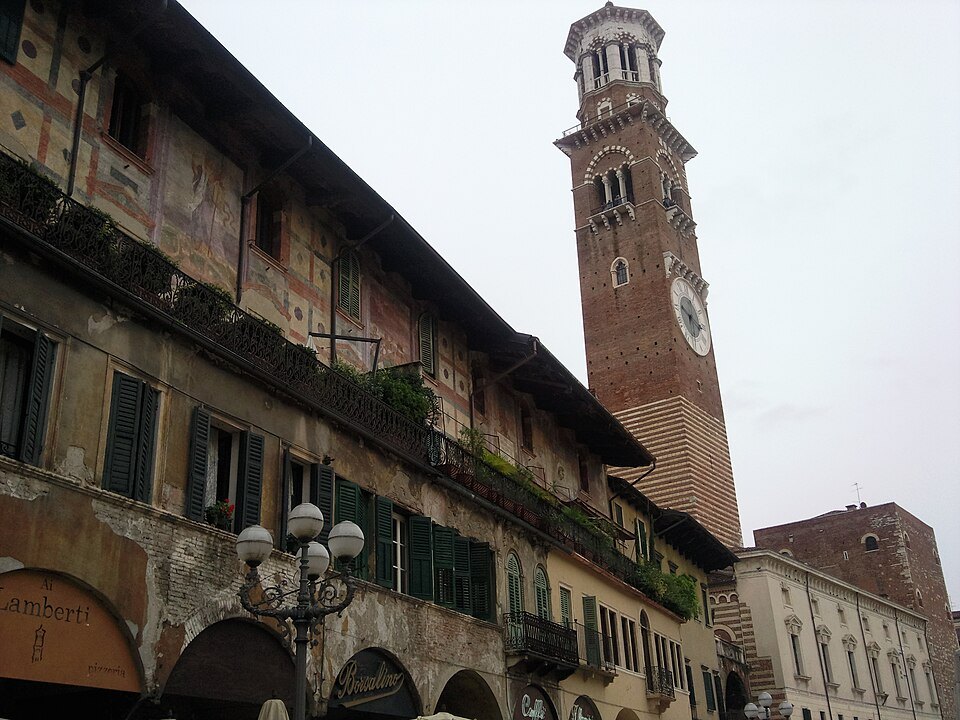 Painted house fronts on Piazza delle Erbe under the Torre dei Lamberti